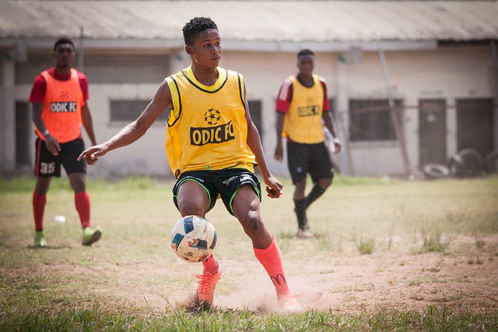 A young boy participates in a game during a tournament organized by two football academies based in Satellite Town, Lagos. During such tournaments, young football hopefuls have a chance to showcase their talents to scouts from Europe hoping to earn a move to a European club. Lagos, Spring 2016. (Photo Paweł Banaś)