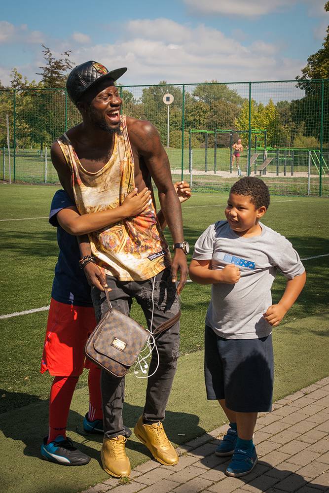 Children of park regulars swarm Olabanji to take the ball away from him during a game in the park. Most of the kids are enrolled in local youth academies and, like their fathers, dream of becoming professional footballers. Warsaw, Summer 2016. (Photo Paweł Banaś)